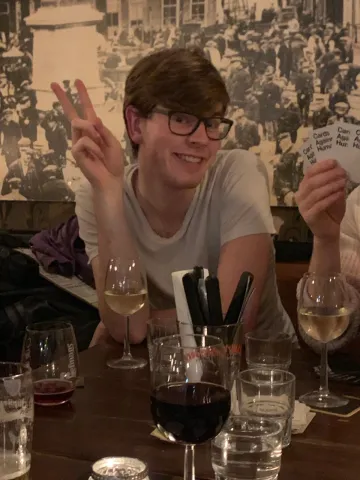 Willem met een wijntje die lacht